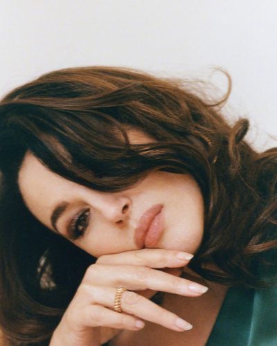 Monica Bellucci in a refined beige dress with contemporary design.