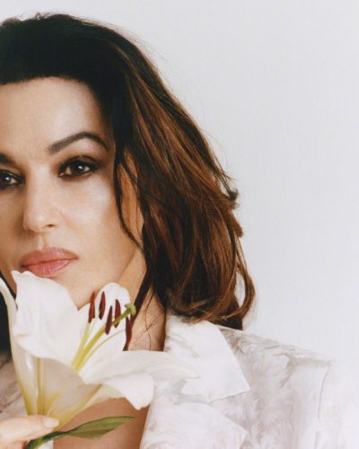 Monica Bellucci wearing a fashionable beige dress with puff sleeves.