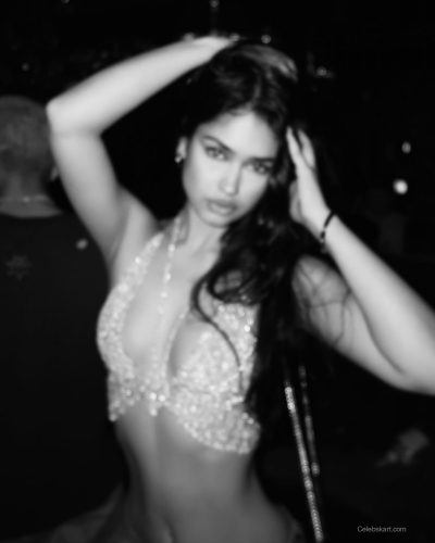 Naaz Torbati wearing a silver top with blue denim.