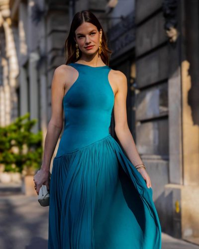 Nadine Leopold modern emerald green gown paired with gold earrings