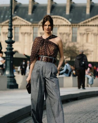 Nadine Leopold wearing high-waisted checkered trousers and wide belt