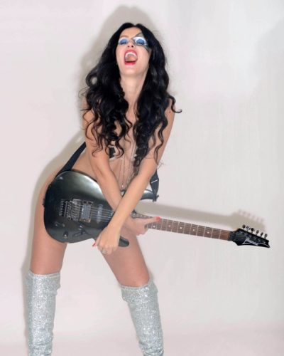 Natasha Blasick in black bodysuit with high-shine silver boots.