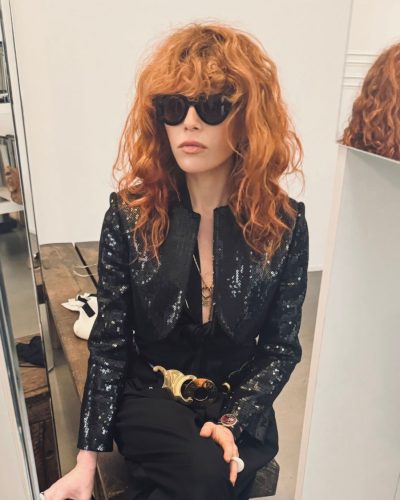 Natasha Lyonne vibrant red curls framing her face