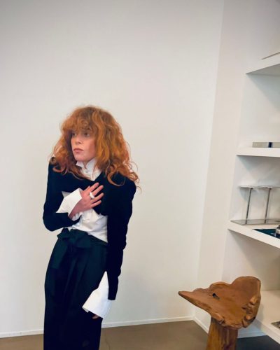 Natasha Lyonne stylish black boots complementing her ensemble
