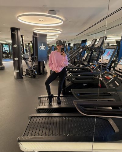 Nazanin Mandi in black sports bra and pink oversized sweatshirt