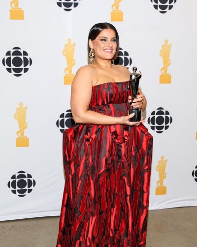 Nelly Furtado in a bold red gown with unique details