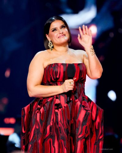 Nelly Furtado in a captivating red gown with texture