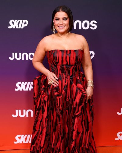 Nelly Furtado wearing a flowing red gown with shine