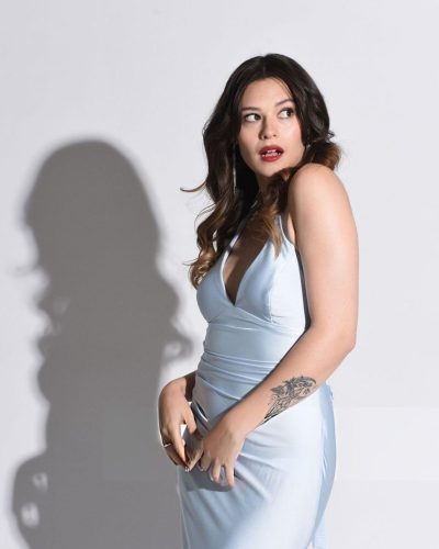 Nicole Maines radiant smile enhancing the light blue dress