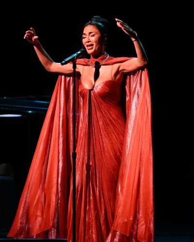 Nicole Scherzinger wearing a vibrant red dress with ruched details