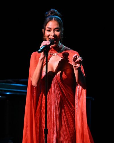 Nicole Scherzinger in a red pleated gown with shimmering fabric
