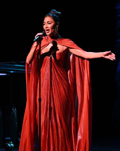 Nicole Scherzinger in a red gown with intricate pleats