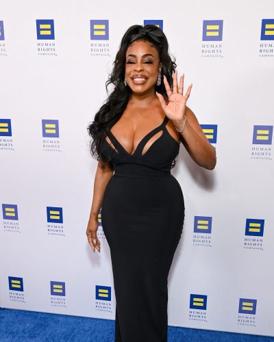 Niecy Nash in a fitted black gown featuring modern cutouts