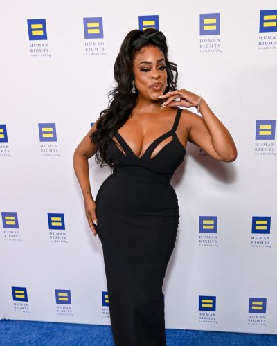 Niecy Nash in a black gown paired with sparkling earrings