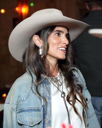 Nikki Reed wearing turquoise pendant necklaces and rings