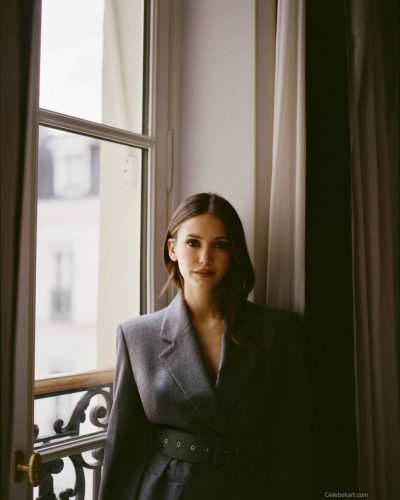 Nina Dobrev in gray coat with subtle sheen fabric