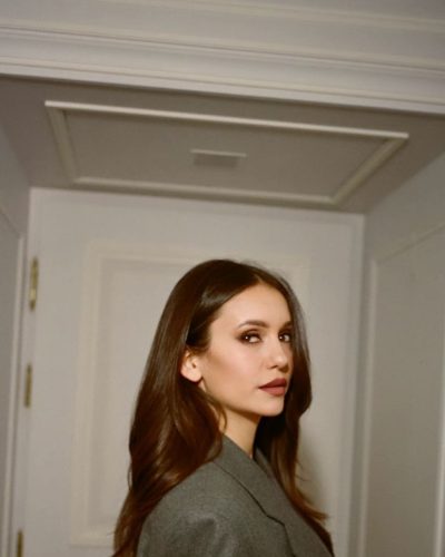 Nina Dobrev in soft waves hairstyle and gray coat