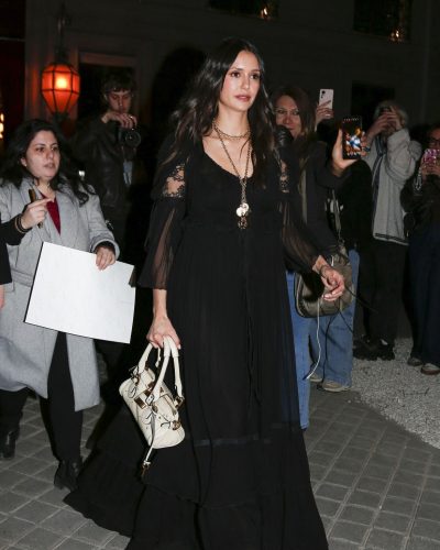 Nina Dobrev accessorized with a gold chain necklace