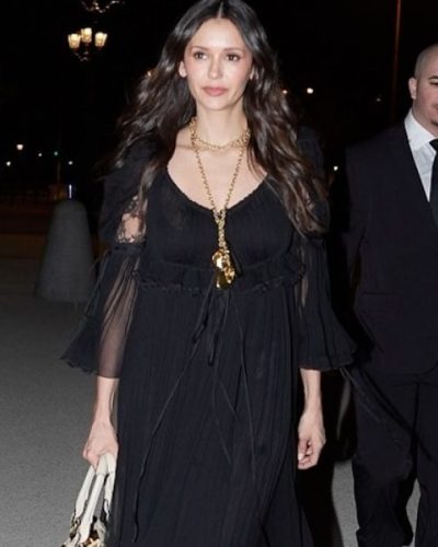 Nina Dobrev in a black dress featuring billowing sleeves