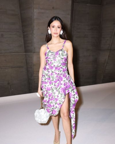 Nina Dobrev flower-shaped earrings complementing her dress