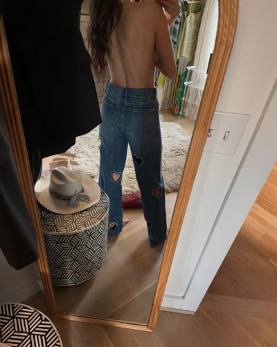 Nina Dobrev tailored black trousers and oversized sunglasses