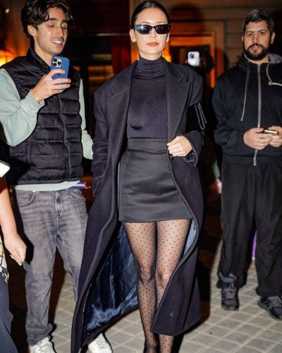 Nina Dobrev fitted mini skirt paired with black trench coat