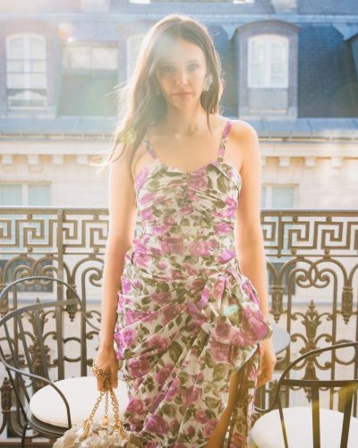 Nina Dobrev black flowing gown complemented by bold gold necklace