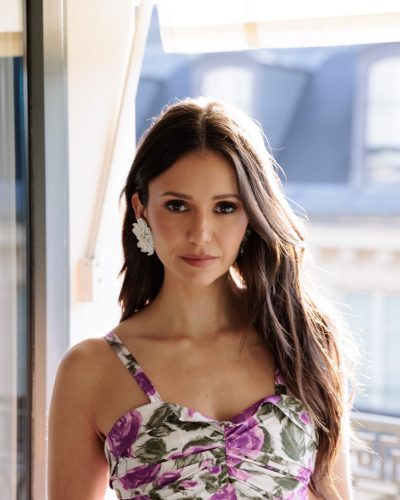 Nina Dobrev black dress with soft fabric and luxurious gold necklace