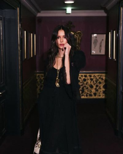 Nina Dobrev black gown featuring graceful neckline and intricate details