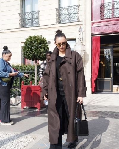 Nina Dobrev high-waisted black jeans with gold belt