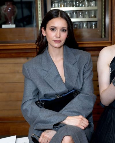 Nina Dobrev stylish black handbag paired with gray attire