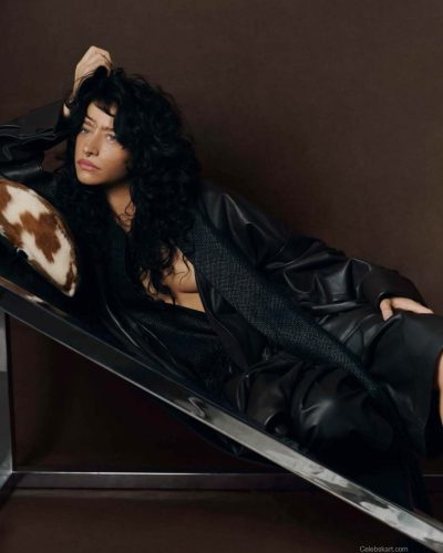 Odessa A’zion sports a tailored oversized shirt in soft beige.