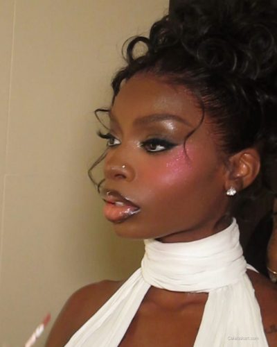 Olandria in a bold red dress with elegant silhouette