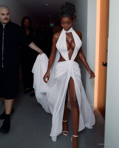 Olandria wearing a skin-tight red gown with minimalistic straps