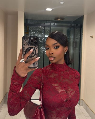 Olandria in a sleek red gown with reflective finish