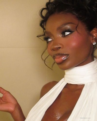 Olandria in a vibrant red latex dress with chic handbag