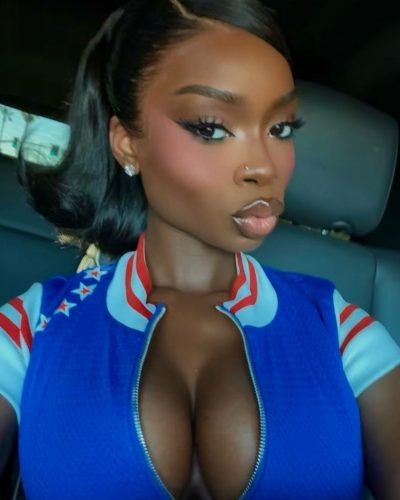 Olandria wearing a skin-tight red gown in luxurious setting