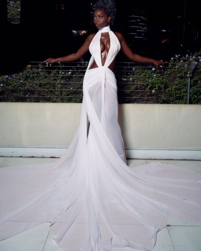 Olandria in a striking red gown paired with small handbag