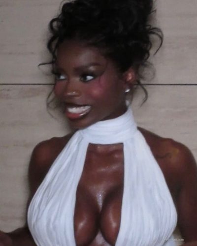 Olandria in a glossy red dress with plunging neckline