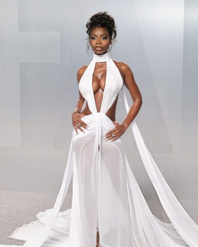 OLANDRIA in white gown with intricate cutouts and plunging neckline