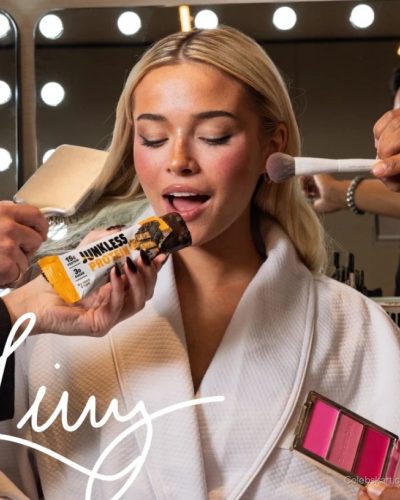 Olivia Dunne in comfortable white robe with makeup brush in hand