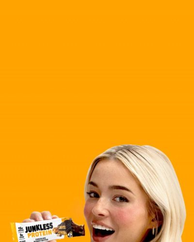 Olivia Dunne in white robe complemented by soft waves hairstyle