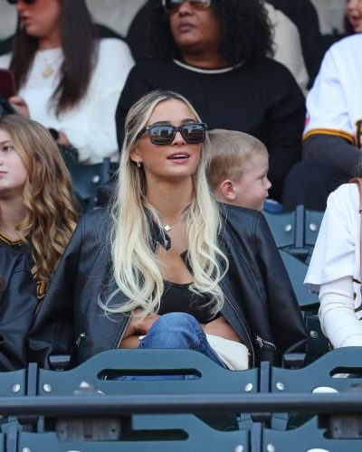 Olivia Dunne wearing fitted black tank top and classic blue jeans