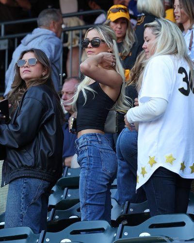 Olivia Dunne in black tank top and blue high-waisted jeans