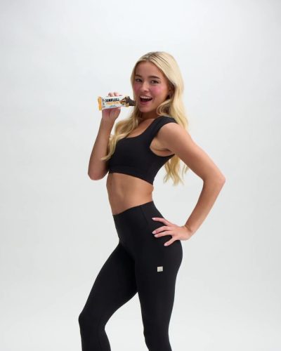 Olivia Dunne wearing black crop top and fitted leggings.