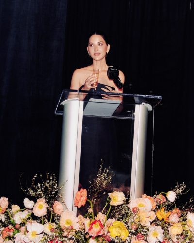 Olivia Munn black gown accentuating shoulders and figure