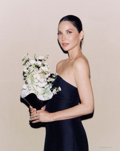 Olivia Munn minimalist black dress with sleek fabric
