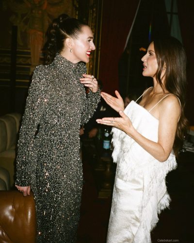 Olivia Munn in a white dress with unique fringe accents