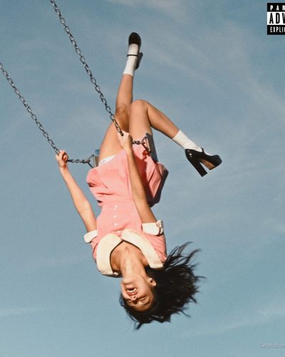 Olivia Rodrigo light pink dress with playful patterns and knee-high socks