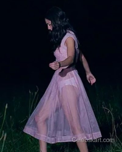 Olivia Rodrigo light pink dress accentuated by black stylish footwear